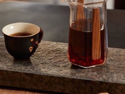 Minimalist clay cup of green tea on stone surface
